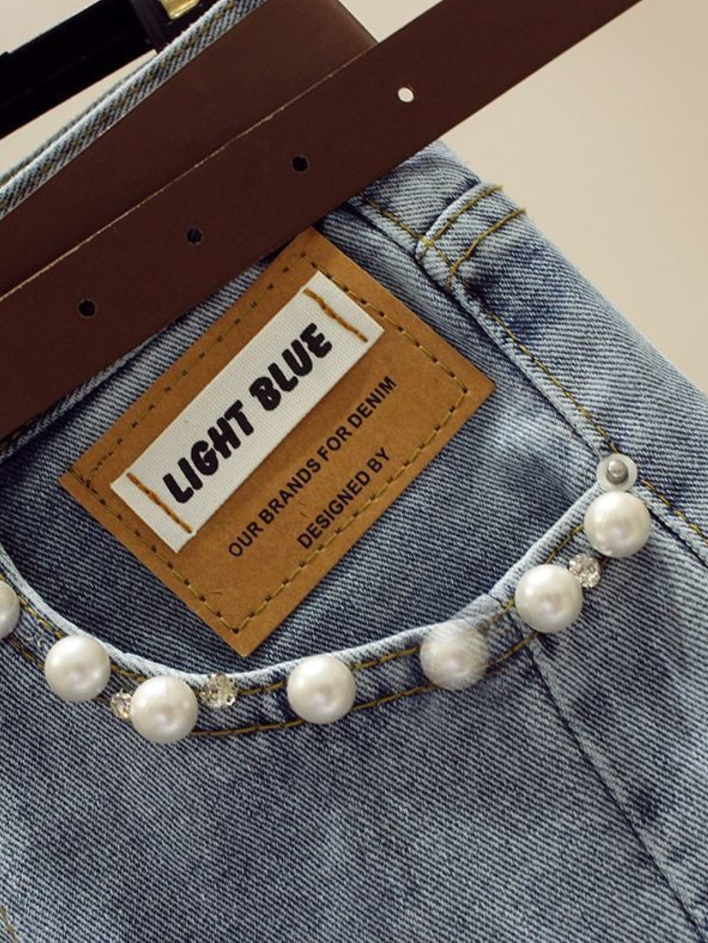 High-Waisted Slim-Fit Denim Skirt with Pearl-Trimmed Slit & Fringe Hem